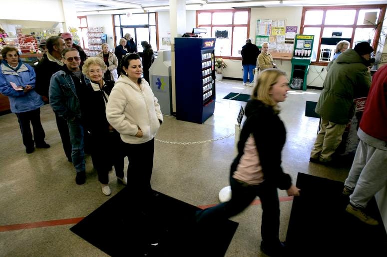 Customers line up to buys Mega Millions lottery tickets at the Penn-Ohio Medicine Mart in Masury, Ohio, on Tuesday, March 6, 2007. The Pennsylvania state line runs right through the store and customers can buy Mega Millions tickets on the Ohio portion of