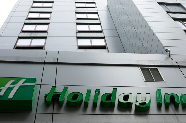 In this file photo dated March 28, 2019, the sign for a Holiday Inn in New York. The fight to save the seas from plastic waste may mean the end for mini bottles of shampoo and other toiletries, after the owner of Holiday Inn and InterContinental Hotels an