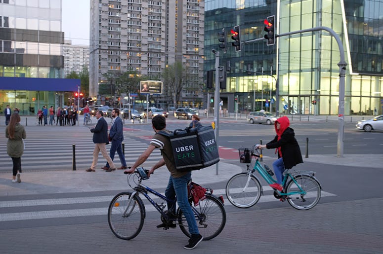 An Uber Eats meal delivery bicyclist arrives at an intersection in the city center on April 18, 2018 in Warsaw, Poland. Uber Eats is the biggest meal delivery service in the USA and is expanding aggressively internationally. (Photo by Sean Gallup/Getty I
