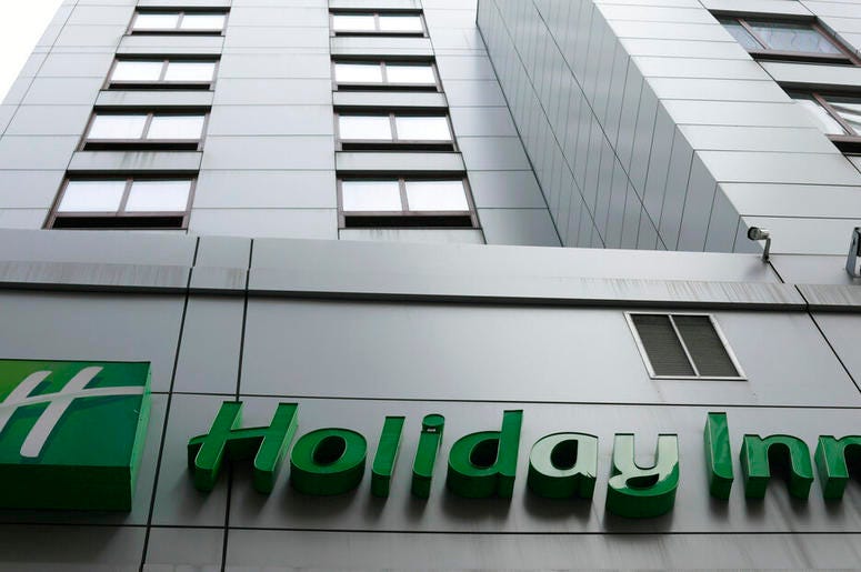 In this file photo dated March 28, 2019, the sign for a Holiday Inn in New York. The fight to save the seas from plastic waste may mean the end for mini bottles of shampoo and other toiletries, after the owner of Holiday Inn and InterContinental Hotels an