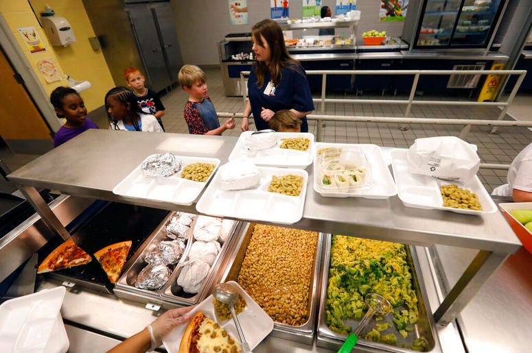 A teacher lines up the students for school-prepared lunches at Madison Crossing Elementary School in Canton, Miss., Friday, Aug. 9, 2019. Scott Clements, director of child nutrition at the Mississippi education department, said they've ordered two trucklo