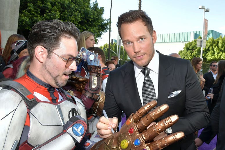 (Amy Sussman/ Getty Images) Chris Pratt signs a Thanos gauntlet replica worn by an Iron Man lookalike at the premiere of Avengers: EndGame