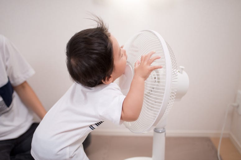 baby and a fan