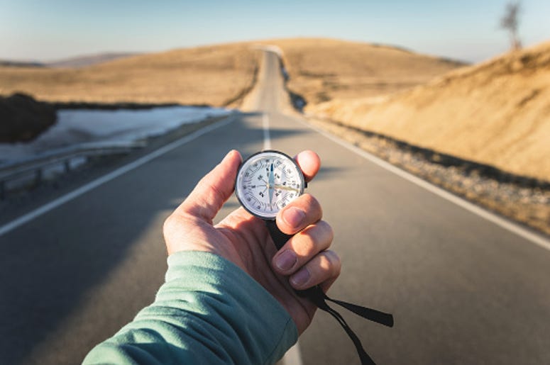 Person holding a compass