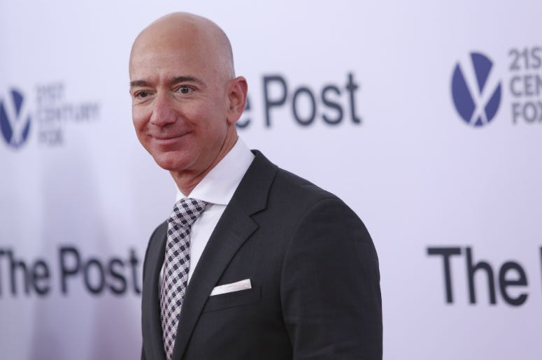 Jeff bezos poses as he arrives on the red carpet for 'The Post' premier at the Newseum Jeff Bezos,Salary,Median,Amazon,10 Seconds,Money,Rich,Executives,CEO,Radio,Employees,ALT 103.7