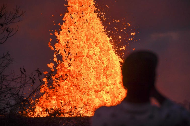 A resident watches lava from Kilauea Volcano shoot into the air out of cracks in the earth. Hawaii,Tourists,Arrested,Selfie,Lava,Eruption,Volcano,Mt. Kilauea,National Guard,Police,Fine,Jail,ALT 103.7