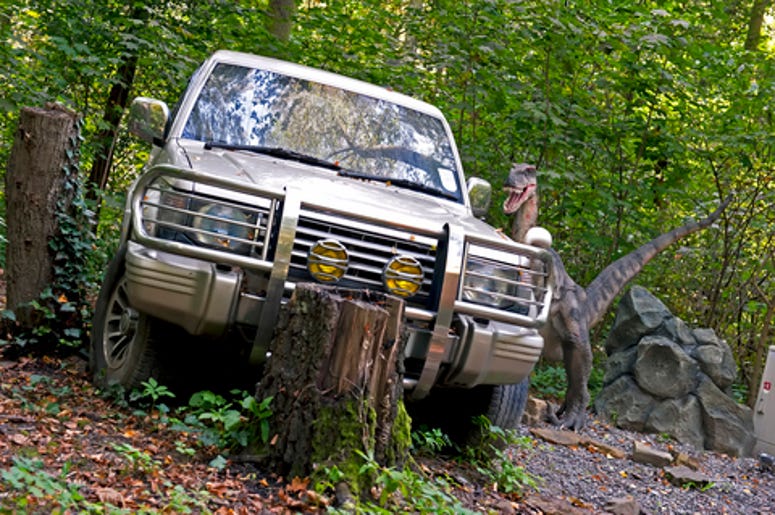 Dinosaur and a broken down car