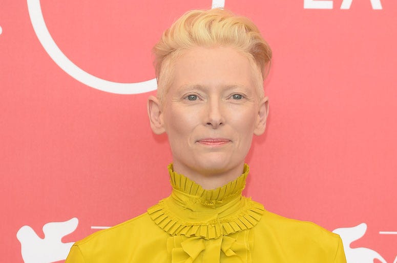 Tilda Swinton, Red Carpet, Yellow Dress, Pink Background Tilda Swinton, Red Carpet, Yellow Dress, Pink Background