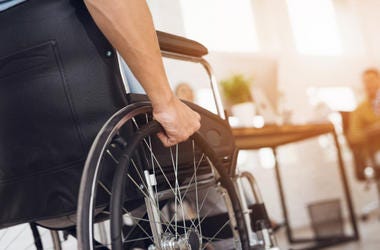 A disabled man is sitting in a wheelchair A disabled man is sitting in a wheelchair