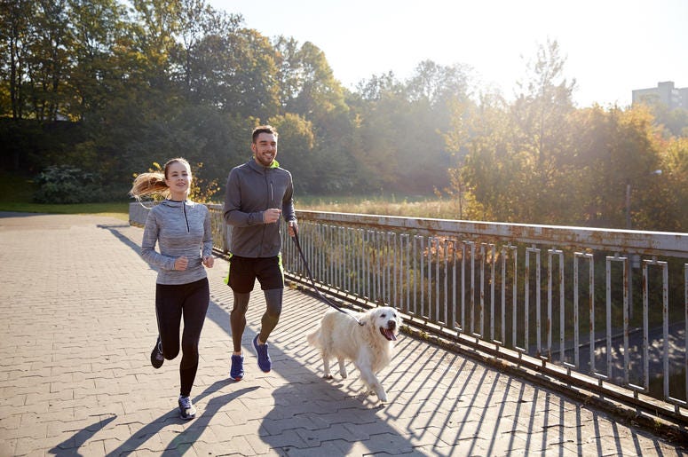 people Jogging With Their Dog