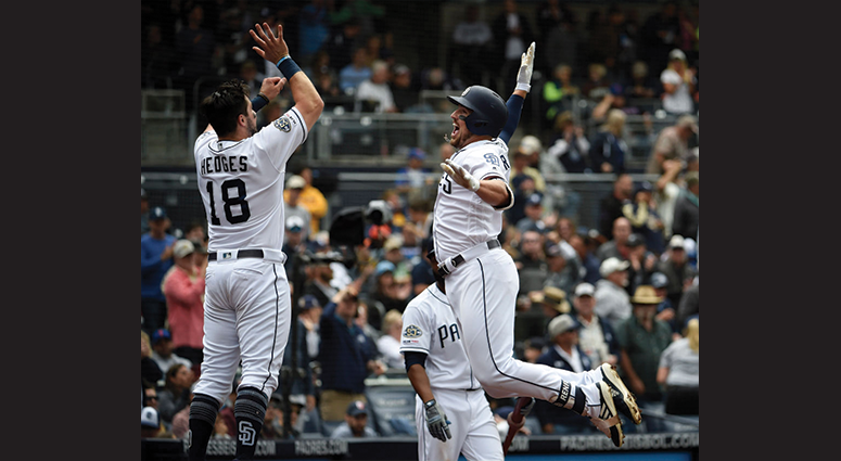 Hunter Renfroe #10 of the San Diego Padres is congratulated by Austin Hedges #18 after hitting a solo home run during the seventh inning of a baseball game against the New York Mets at Petco Park May 8, 2019 in San Diego, California. (Photo by Denis Poroy