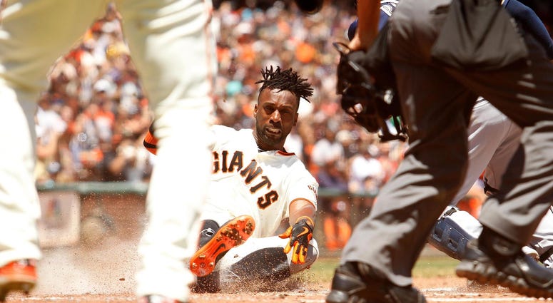 Andrew McCutchen Sliding Into Home Plate Andrew McCutchen of the San Francisco Giants