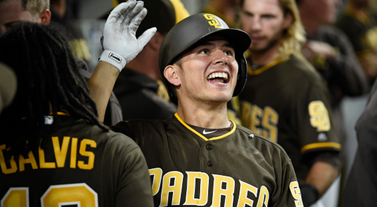 AUGUST 31: Luis Urias #9 of the San Diego Padres is congratulated after hitting a two-run home run during the eighth inning of a baseball game against the Colorado Rockies at PETCO Park on August 31, 2018 in San Diego, California. (Photo by Denis Poroy/Ge