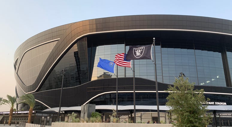 Flags fly outside of Allegiant Stadium