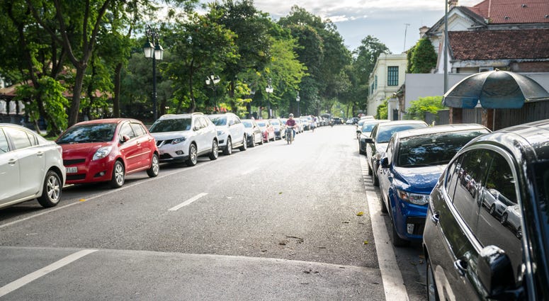Parallel parking cars on urban street.