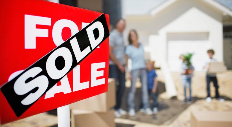 House sold with happy family in the background
