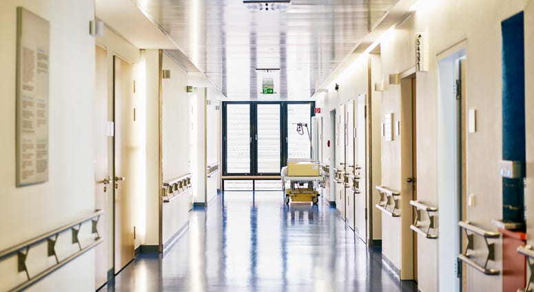 Hospital with corridor and bed without persons in landscape format