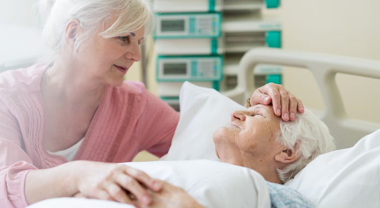 Daughter visiting her senior mother in hospital