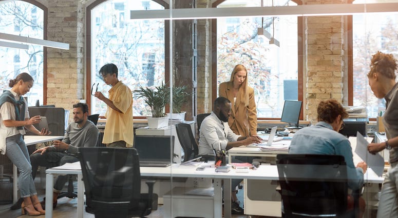 Group of young mixed race business people working together in the creative office.