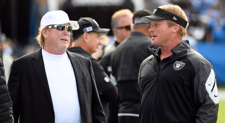 Oakland Raiders owner Mark Davis greets head coach Jon Gruden of the Oakland Raiders before the start of the game against Los Angeles Chargers at Dignity Health Sports Park on December 22, 2019