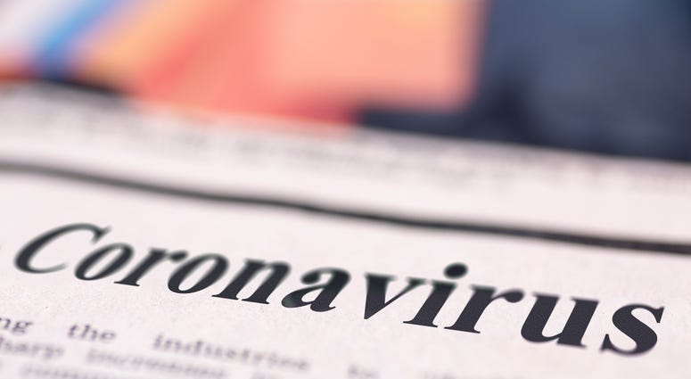 Coronavirus written newspaper close up shot to the text.