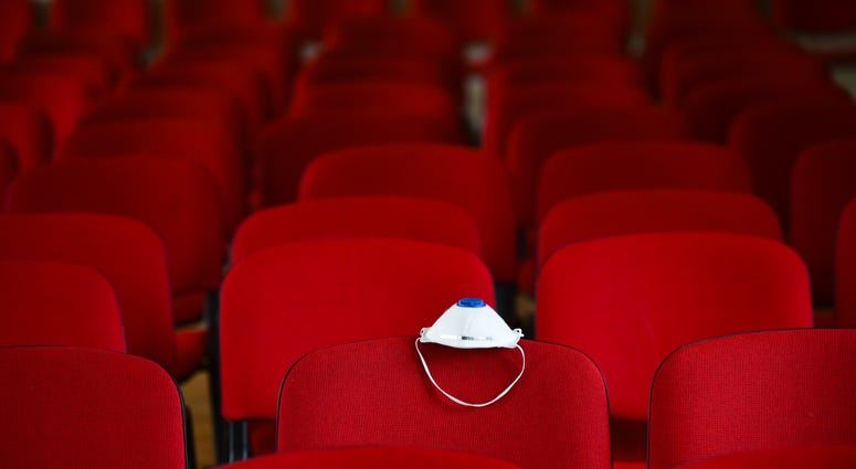 Movie theater with face covering for coronavirus protection