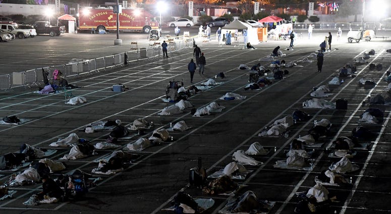 People are shown in social-distancing boxes at a temporary homeless shelter set up in a parking lot at Cashman Center on March 30, 2020 in Las Vegas, Nevada