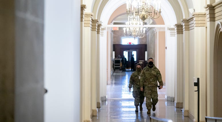 Members of the National Guard walk through the U.S. Capitol on January 11, 2021 in Washington, DC.