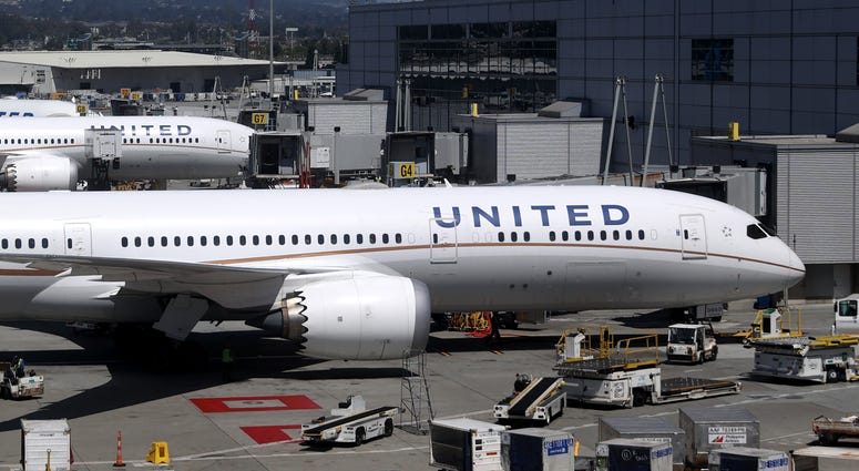United Airlines workers load cargo onto a plane at San Francisco International Airport on July 08, 2020 in San Francisco, California.