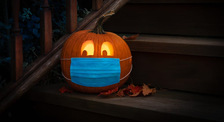 Lighted Halloween Pumpkin Jack o Lantern Wearing Covid PPE Mask On Steps