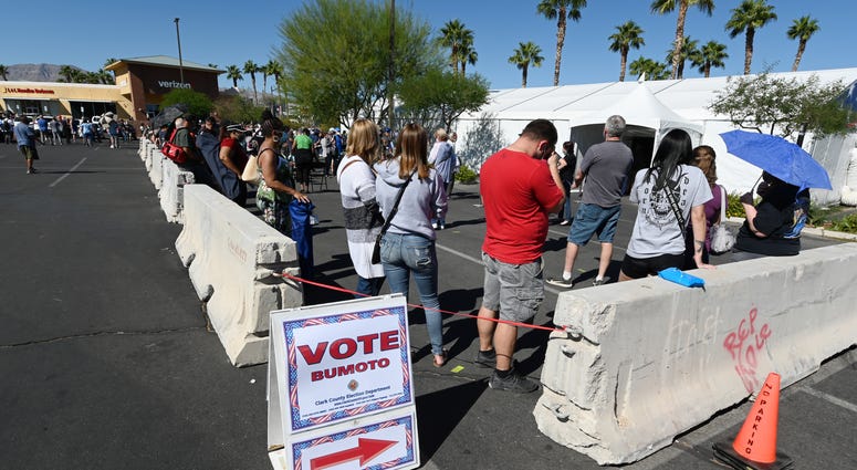 People line up to vote at a shopping center on the first day of in-person early voting on October 17, 2020 in Las Vegas, Nevada. Early voting for the general election in the battleground state continues through October 30.