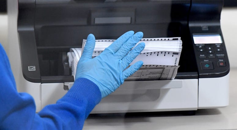 A Clark County election worker scans mail-in ballots at the Clark County Election Department on October 20, 2020 in North Las Vegas, Nevada. In-person early voting for the general election in the battleground state began on October 17 and continues throug