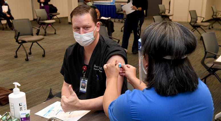 Dr. David Obert gives a thumbs-up after receiving a Pfizer-BioNTech COVID-19 vaccination at University Medical Center of Southern Nevada on December 16, 2020, in Las Vegas, Nevada.