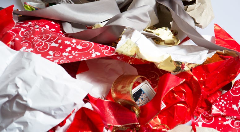 A bunch of used, torn up holiday gift wrapping paper