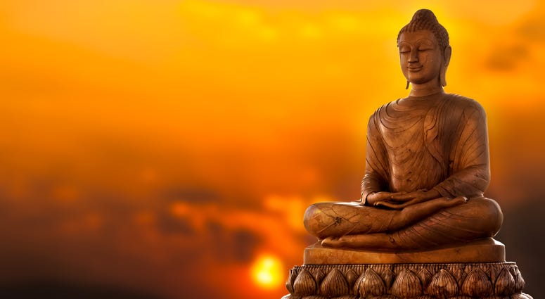 Buddha Statue and sunset background