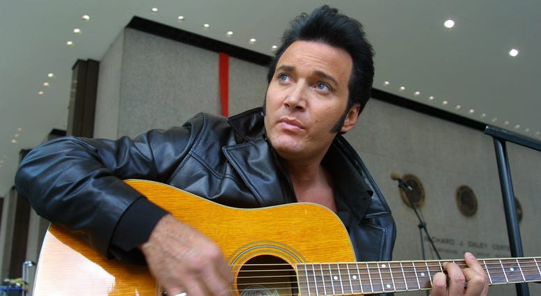 Elvis entertainer Trent Carlini warms up on his guitar prior to an afternoon performance January 5, 2000 at the Daley Center in Chicago.