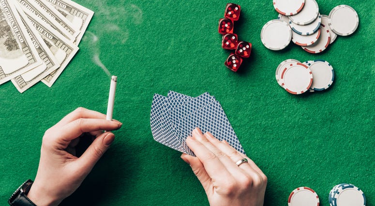 Woman smoking at a poker table