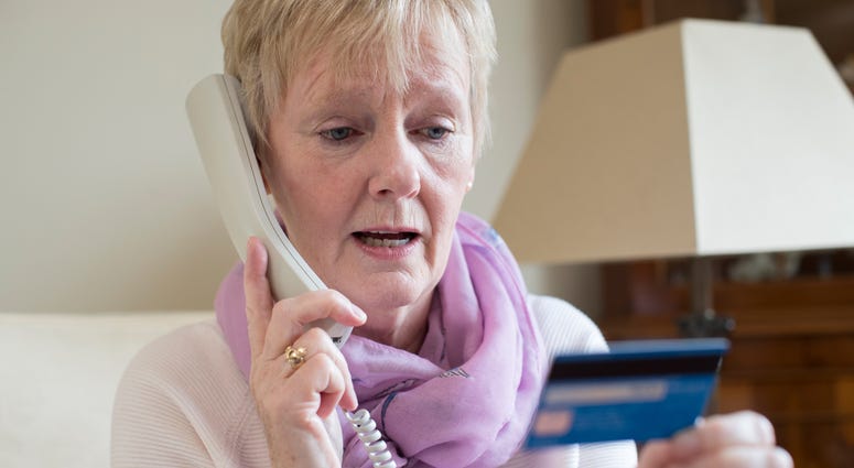 Senior woman giving credit card info over the phone