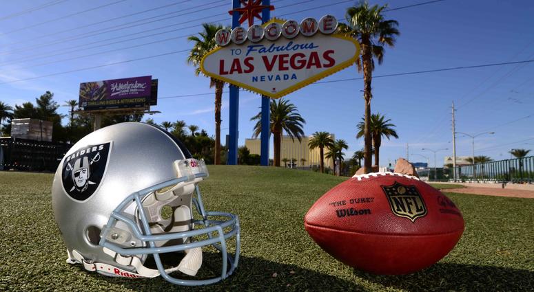 Shot of Raiders helmet with Las Vegas' "Welcome" sign in the background