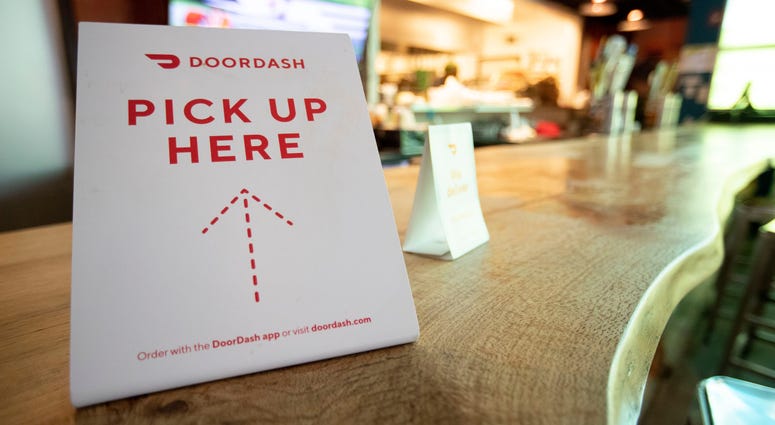 A Door Dash sign sits on the counter Monday, March 16, 2020,