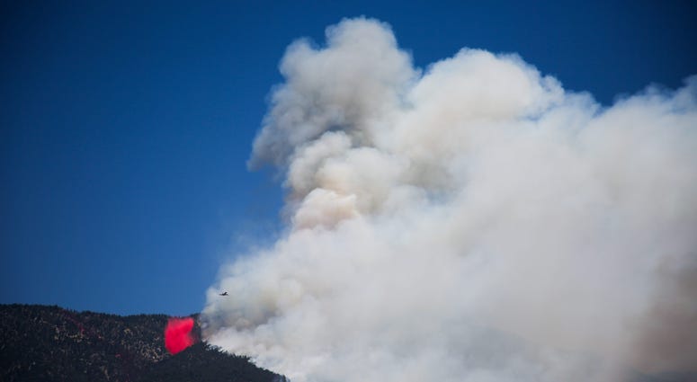 An air tanker drops retardant in Banning, Calif. as the Apple Fire burns on Sunday, August 2, 2020.