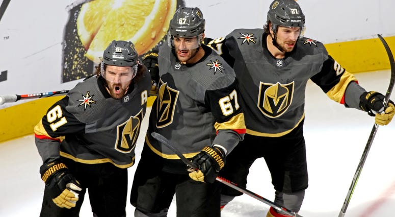 Vegas Golden Knights right wing Mark Stone (61) celebrates scoring a goal with Vegas Golden Knights left wing Max Pacioretty (67) and defenseman Shea Theodore (27) during the second period against the Chicago Blackhawks