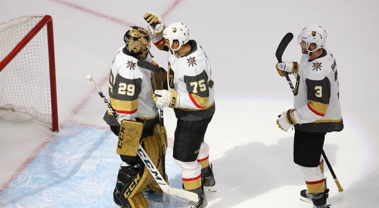 Vegas Golden Knights goaltender Marc-Andre Fleury (29) right wing Ryan Reaves (75) and defenseman Brayden McNabb (3) celebrate the 5-3 victory against the Vancouver Canucks
