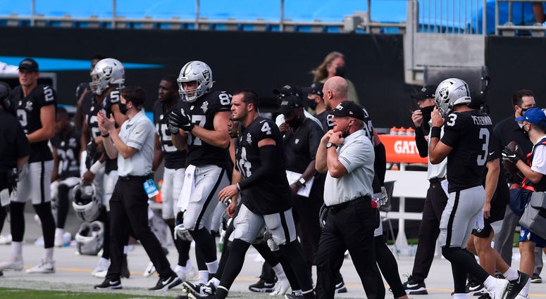 Las Vegas Raiders quarterback Derek Carr (4) and head coach Jon Gruden react after the game at Bank of America Stadium.