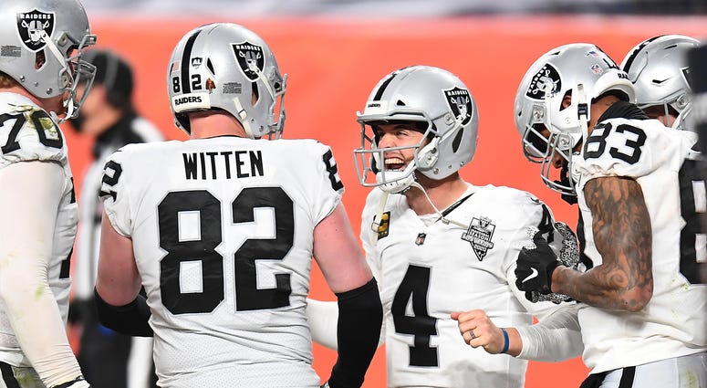 Raiders quarterback Derek Carr (4) and tight end Jason Witten (82) and tight end Darren Waller (83) celebrate a two point conversation in the fourth quarter against the Denver Broncos at Empower Field at Mile High