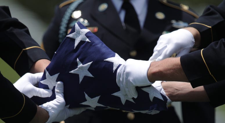 folded flag at veterans day ceremony