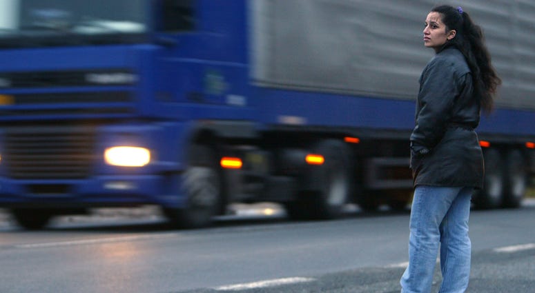 A prostitute waits for customers along the main road to Germany October 21, 2003 in Pilsen, Czech Republic.