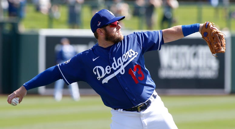 Max Muncy #13 of the Los Angeles Dodgers throws during warm up prior to a Cactus League spring training game against the Chicago White Sox at Camelback Ranch on February 24, 2020 in Glendale, Arizona