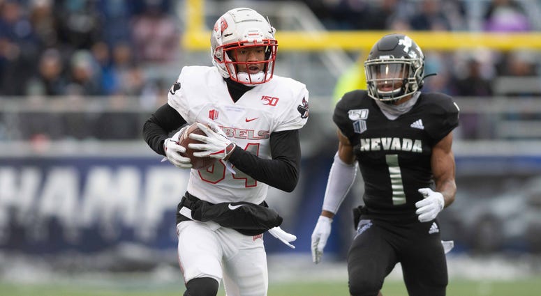 UNLV Rebels wide receiver Steve Jenkins (84) runs after a catch against Nevada Wolf Pack defensive back Berdale Robins (1) at Mackay Stadium