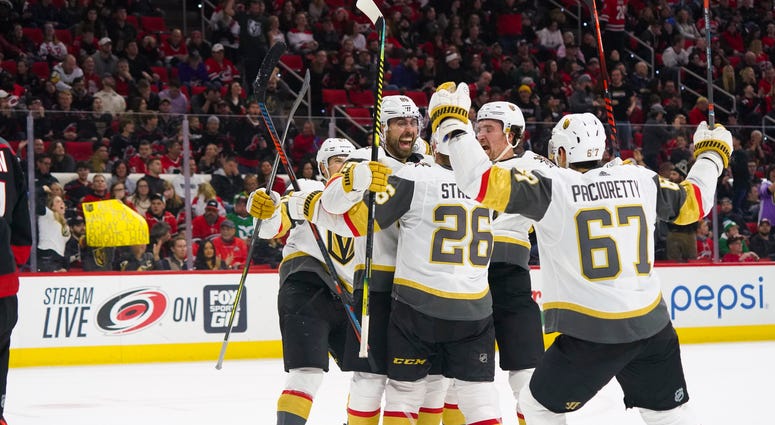 Vegas Golden Knights right wing Alex Tuch (89) is congratulated by center Paul Stastny (26) and right wing Mark Stone (61) and left wing Max Pacioretty (67) after his third period goal against the Carolina Hurricanes at PNC Arena.